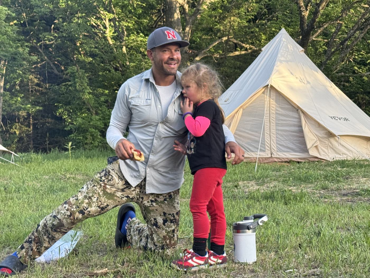 Will with his daughter at a campsite